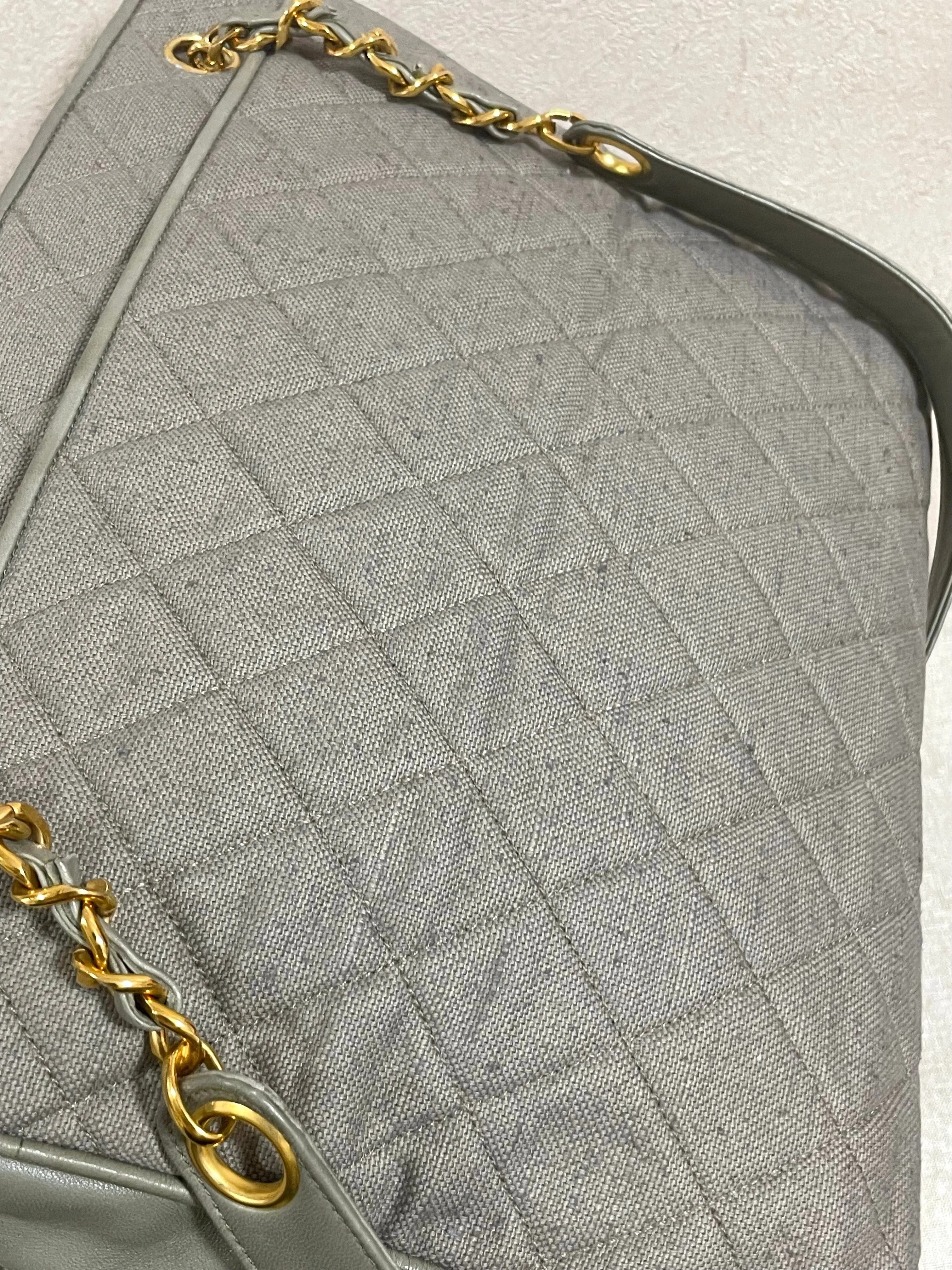 Vintage CHANEL taupe grey canvas and lambskin shoulder tote bag with gold tone chain straps and a CC ball charm. 070125ap1